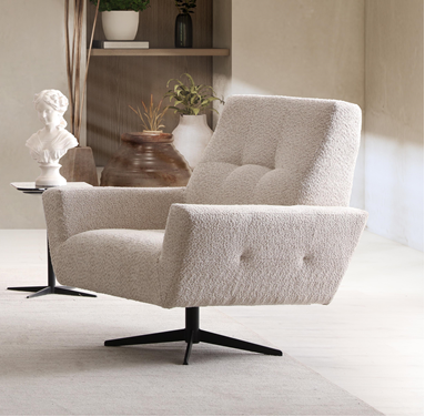 Netline Home Interior Nita armchair with plush fabric upholstery, modern design, and cushioned seat for comfortable accent seating.