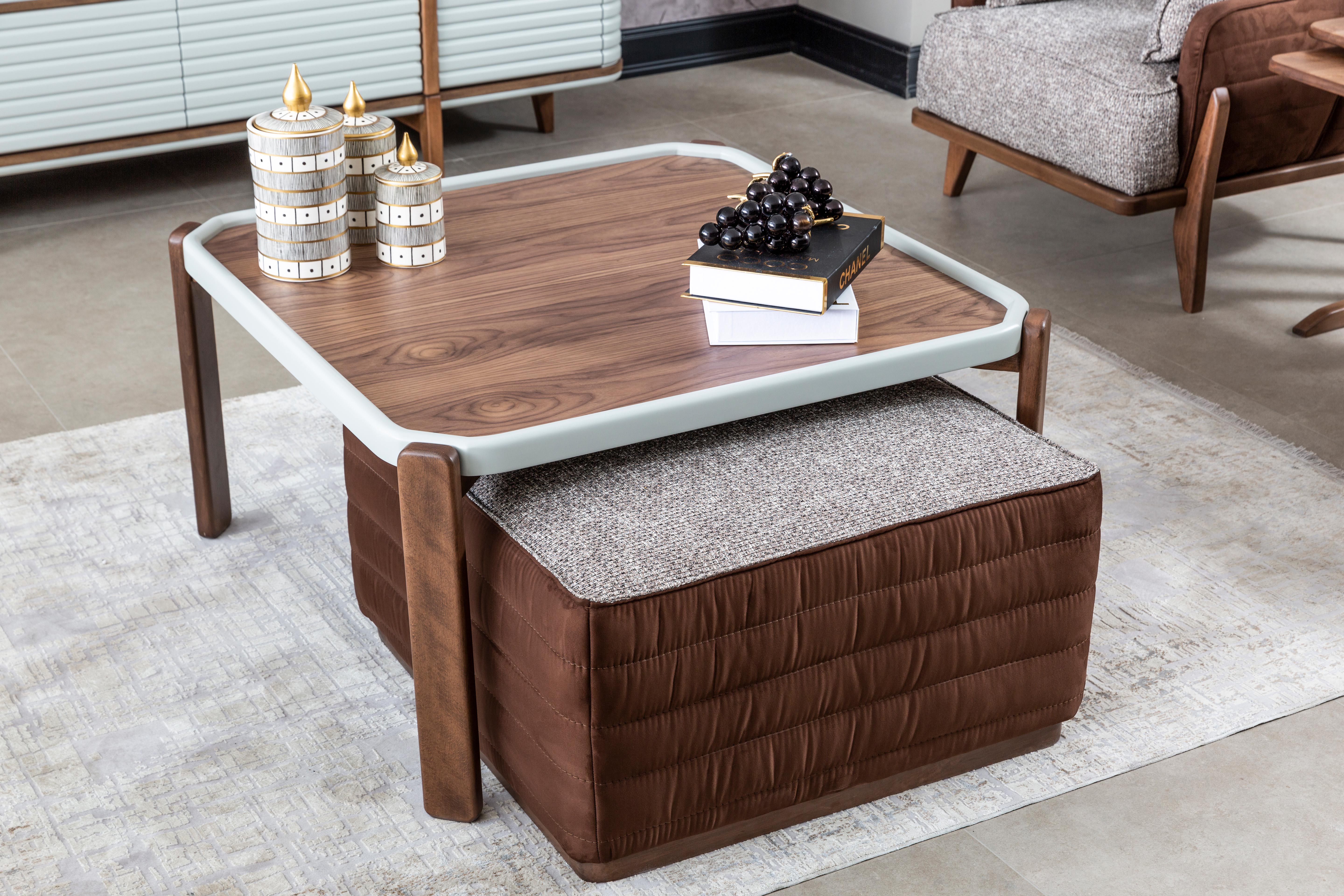 Modern living room with Netline Home Interior Bentley coffee table and puff sofa set, featuring sleek design and comfortable seating.