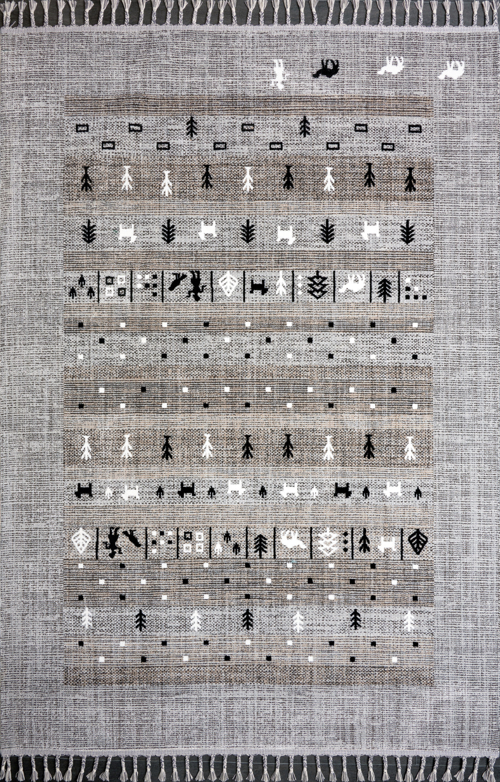 Gray and black tribal flatweave indoor outdoor rug with geometric pattern and tassels by Netline Home, suitable for versatile spaces.