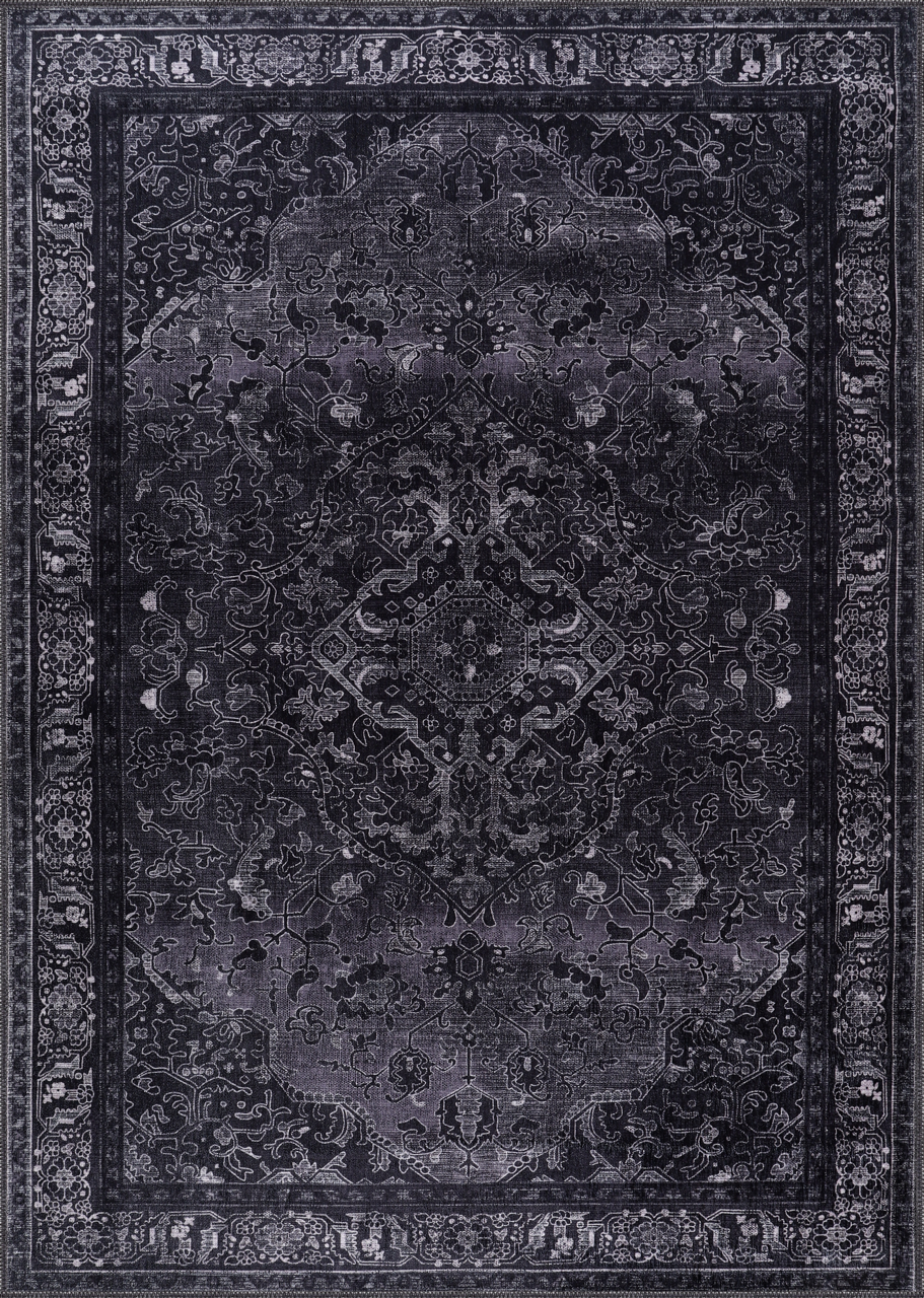 Dark gray area rug with intricate patterns on a matching background