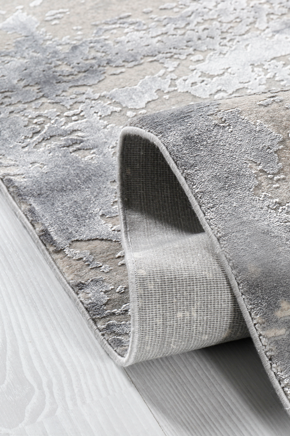Roll of textured gray wallpaper on a light gray background