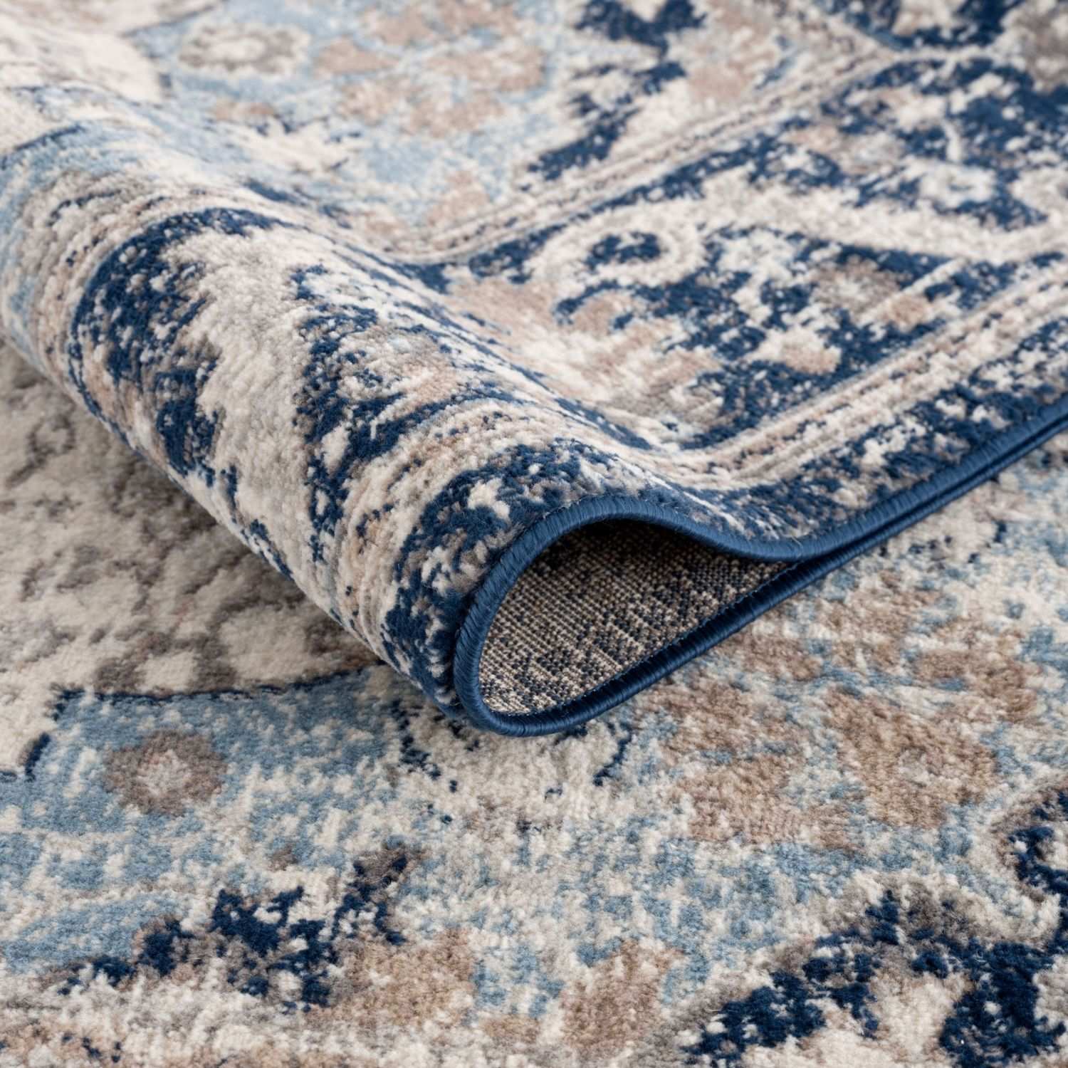 Montana Oriental Blue Rug by The Rugs, showcasing intricate blue and beige patterns on a soft woven surface.