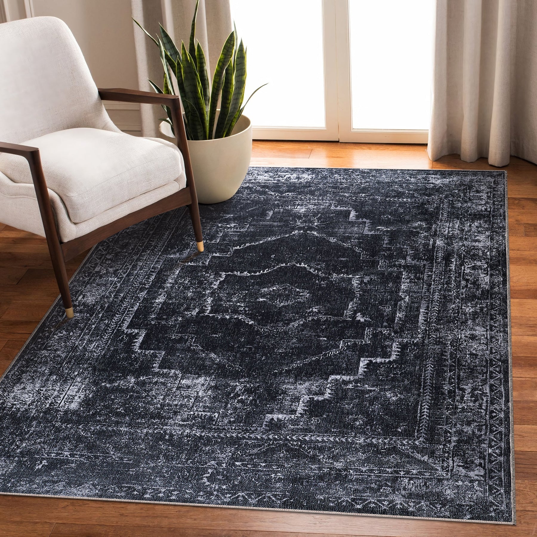 Machine washable black rug with vintage medallion design by Netline Home, suitable for living room, bedroom, or office decor.