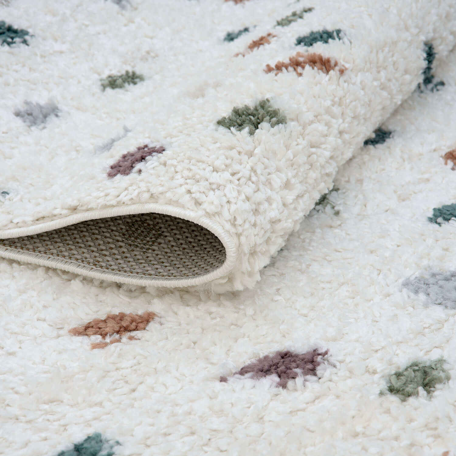 Multicolour Moodi Jubile shaggy runner rug by The Rugs, folded to show vibrant, textured multicolour shaggy surface.