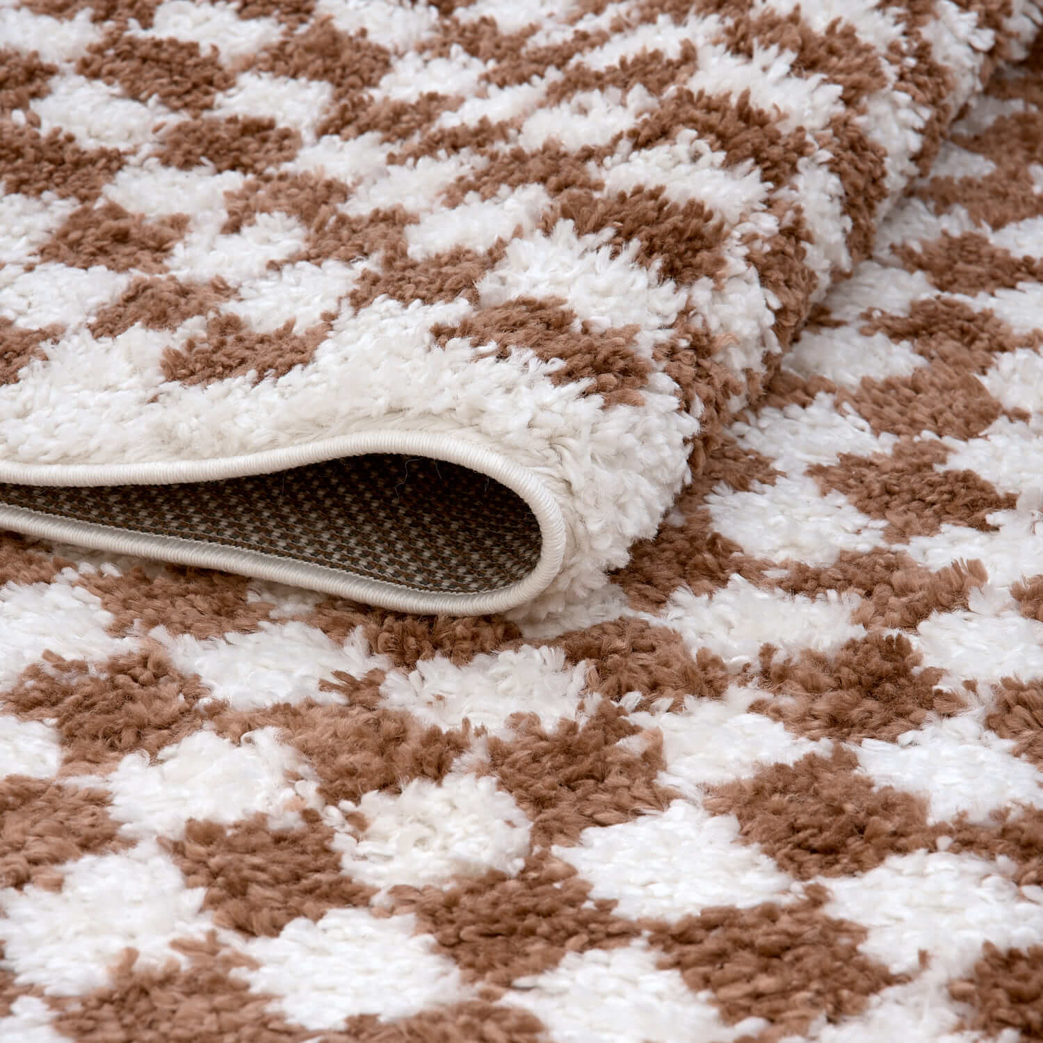 Folded Moodi Shaggy Terra Pixelate Runner Rug by The Rugs, featuring a textured pixelate pattern in earthy tones.