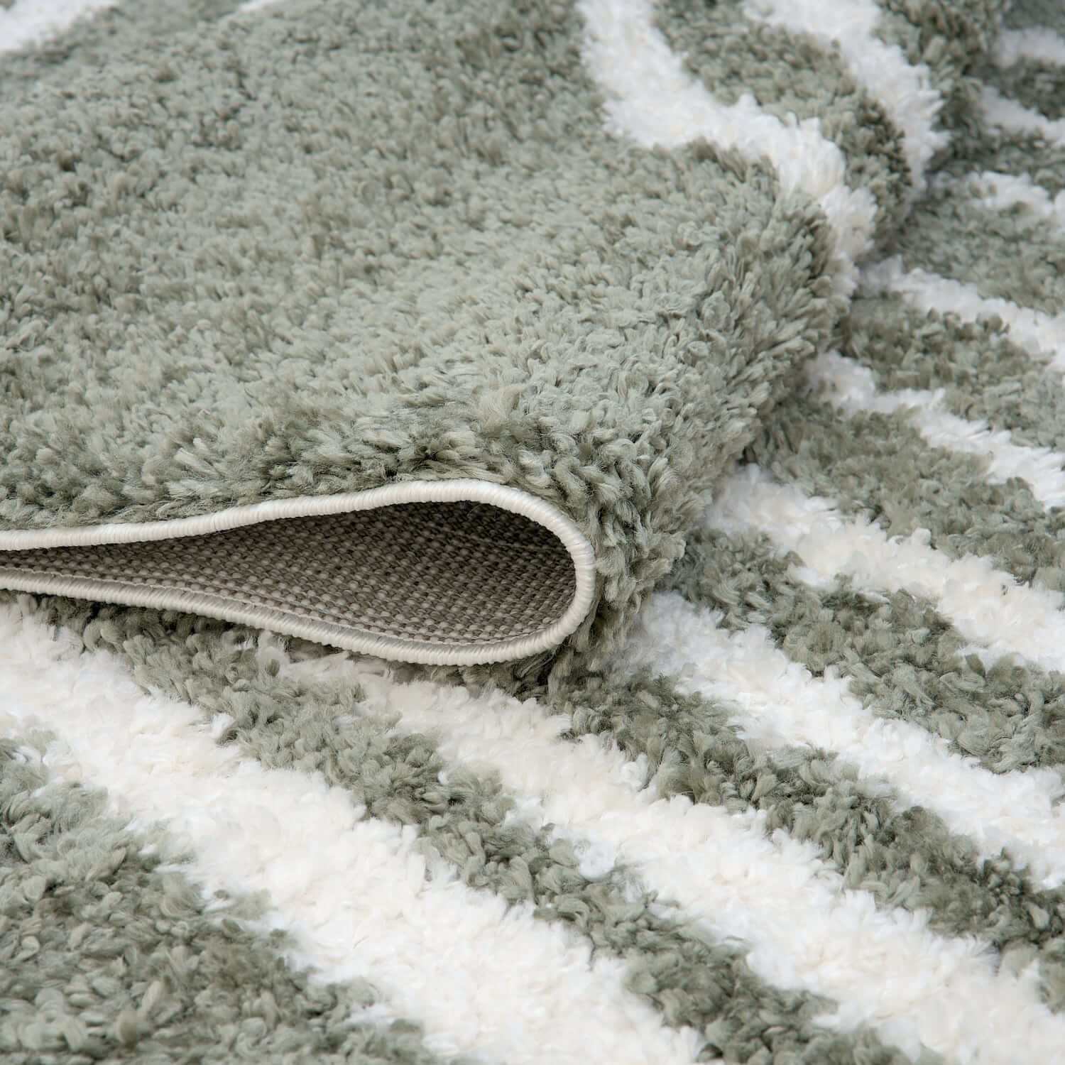 Green Moodi Shaggy Reverie Runner Rug by The Rugs, folded to show soft shaggy texture and vibrant color.