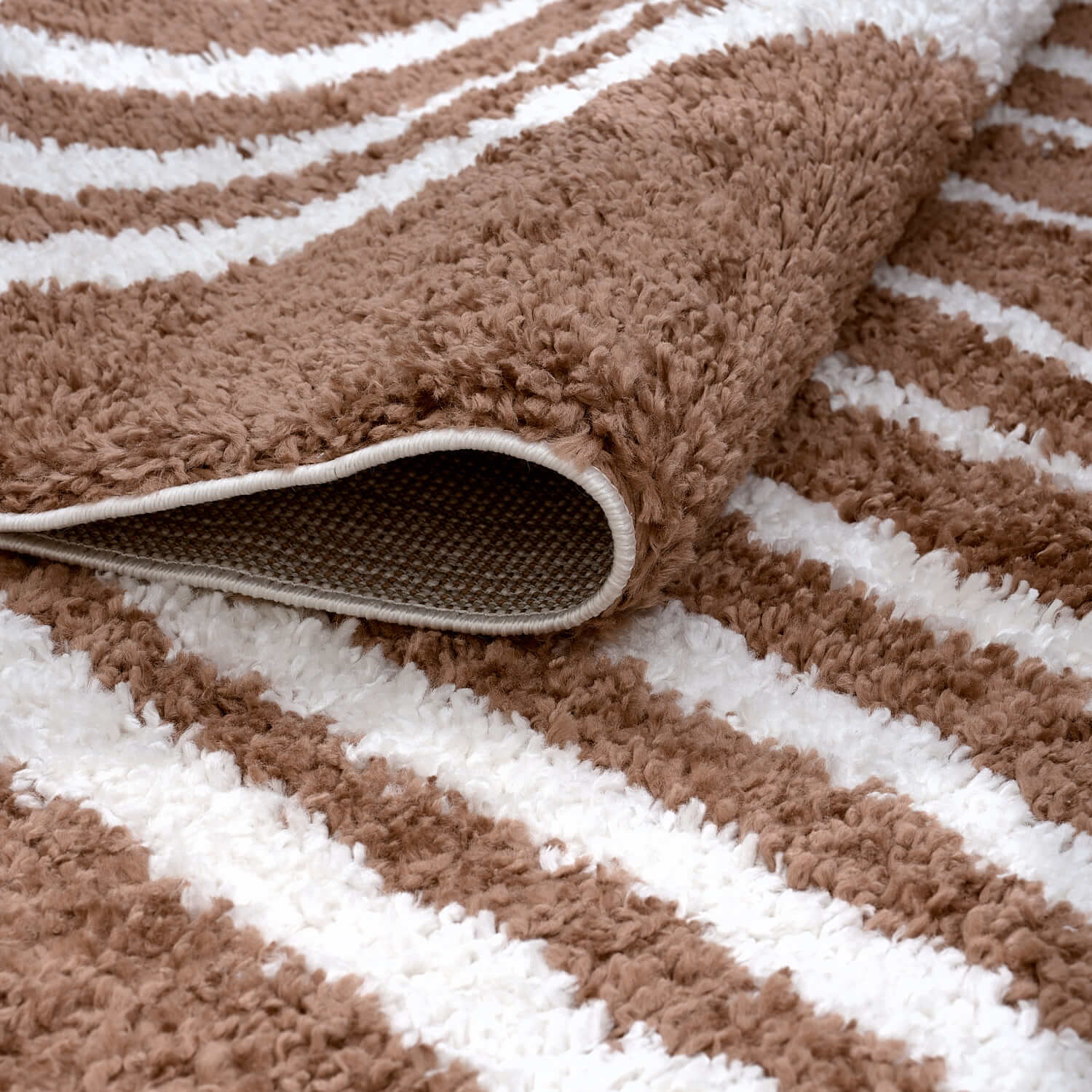 Folded Moodi Shaggy Terra Tawny Runner Rug by The Rugs, featuring soft shaggy texture and warm earthy tones.