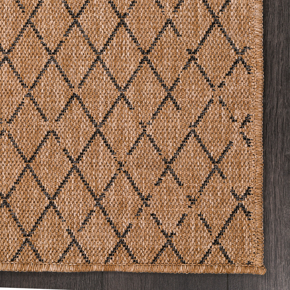 Close-up of Netline Home Diamond Weave Jute-Effect Rug with black geometric pattern, weatherproof, non-slip, washable indoor/outdoor rug