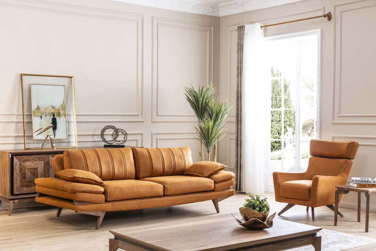 Orange Falcon sofa set by Netline Home Interior, modern living room furniture with plush cushions and sleek design.