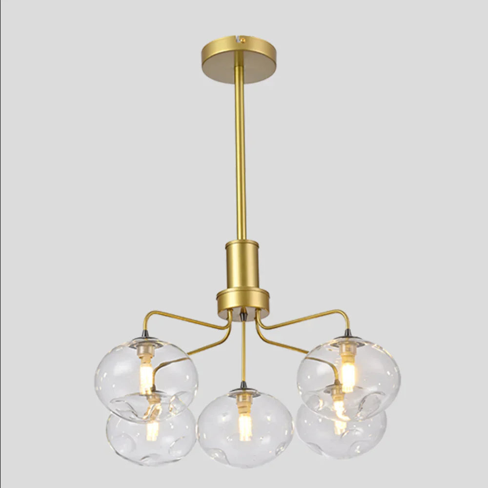 Elegant gold multi-arm dimpled globe ceiling light by Netline Home Interior with multiple spherical glass shades.